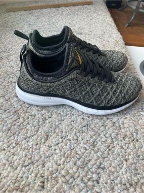 APL women’s Black and Gold Knit Slip-On Sneakers